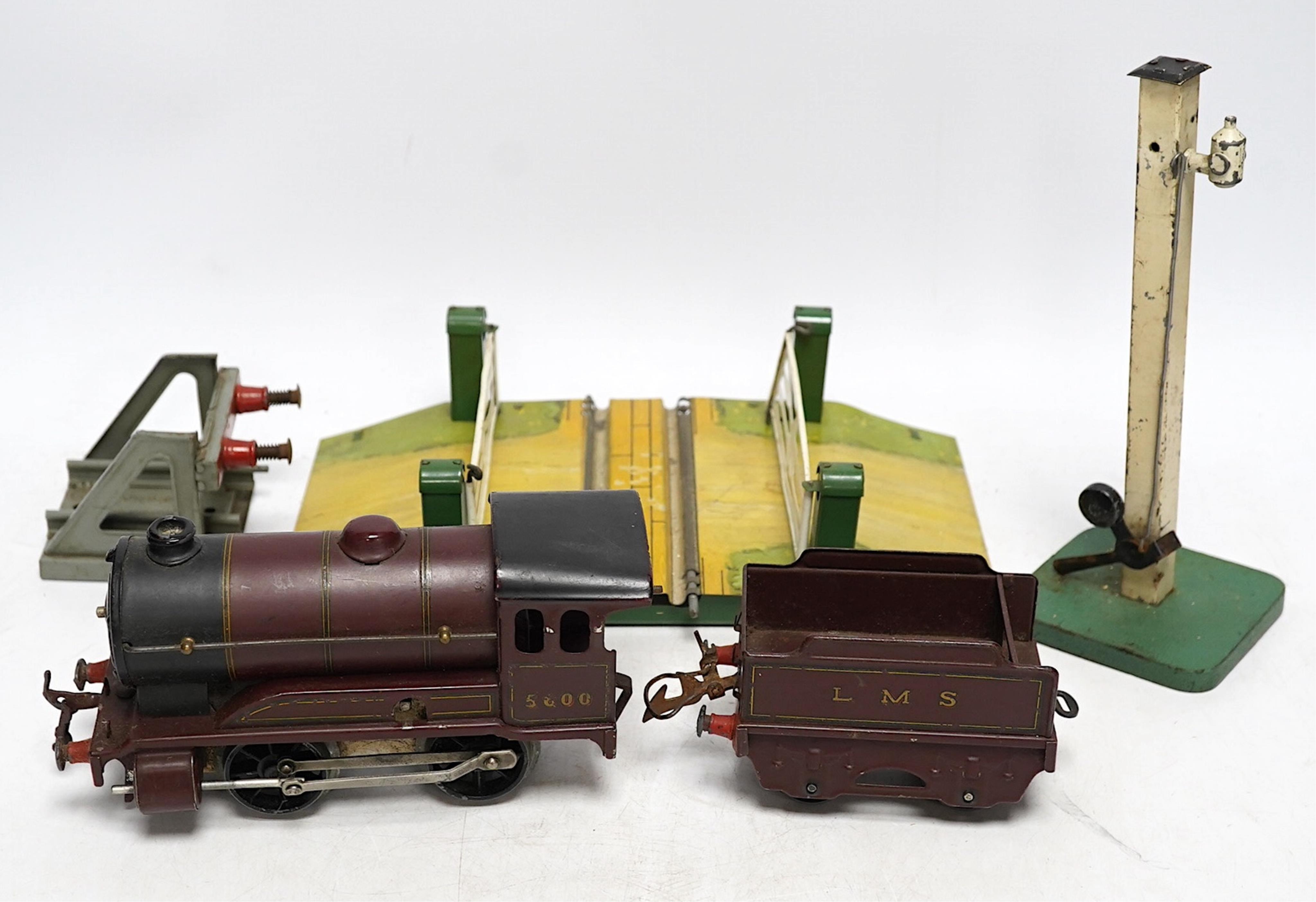 A Hornby 0 gauge clockwork No.501 0-4-0 tender locomotive, a No.1 Level Crossing, buffers and signal. Condition - poor to good, loco in the remains of its box